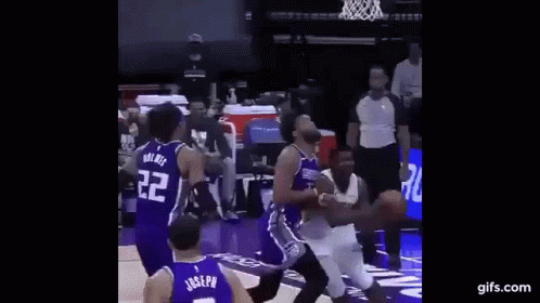 A Basketball Player Is Jumping In The Air To Dunk The Ball During A Basketball Game . GIF