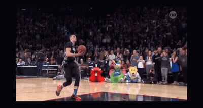 A Basketball Player Is Jumping In The Air To Dunk The Ball GIF