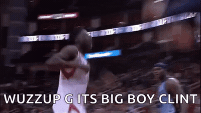 A Basketball Player Is Jumping In The Air While Holding A Basketball In His Hand . GIF
