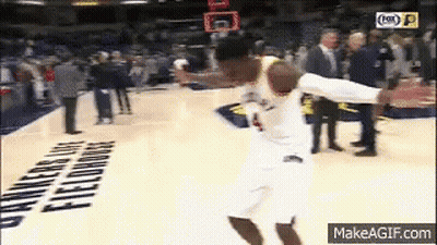 A Basketball Player Is Jumping In The Air While Holding A Basketball . GIF