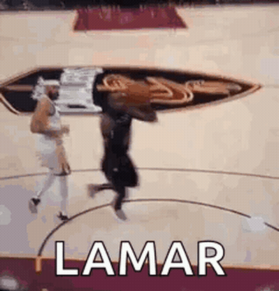 A Basketball Player Is Jumping In The Air While Holding A Basketball On A Basketball Court . GIF
