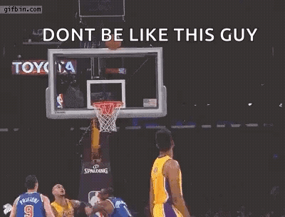 A Basketball Player Is Jumping In The Air With His Arms Outstretched In Front Of A Basketball Net . GIF