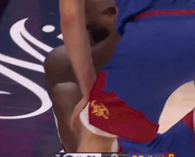 A Basketball Player Is Laying On The Floor With His Knee On The Ground GIF
