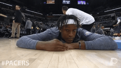 A Basketball Player Is Laying On The Floor With #Pacers Written In The Corner GIF