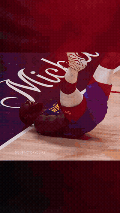 A Basketball Player Is Laying On The Floor With The Number 11 On His Shirt GIF