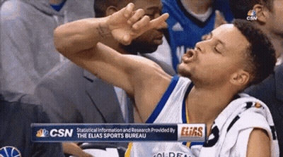 A Basketball Player Is Making A Funny Face In The Stands During A Game . GIF