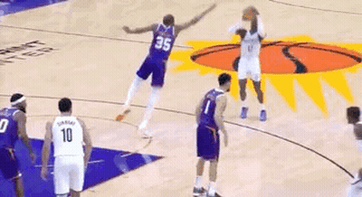 A Basketball Player Is Pointing At Another Basketball Player On A Basketball Court . GIF