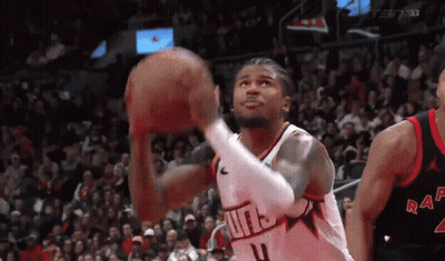 A Basketball Player Is Shooting A Basketball In Front Of A Crowd While Wearing A Number 4 Jersey . GIF