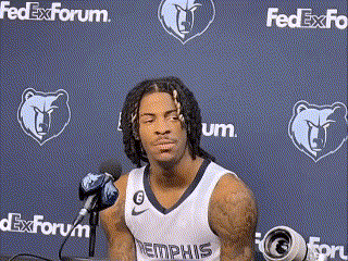 A Basketball Player Is Sitting In Front Of A Microphone In Front Of A Fedex Forum Wall . GIF
