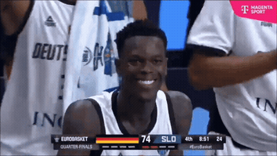 A Basketball Player Is Smiling In Front Of A T-Mobile Ad GIF