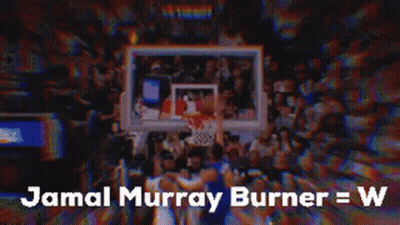 A Basketball Player Is Standing In Front Of A Crowd Of People . GIF