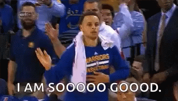 A Basketball Player Is Standing In The Stands With A Towel Around His Neck And A Crowd Applauding . GIF