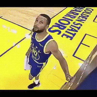 A Basketball Player Is Standing On A Basketball Court Looking Up . GIF
