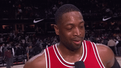 A Basketball Player Is Sweating And Talking Into A Microphone . GIF