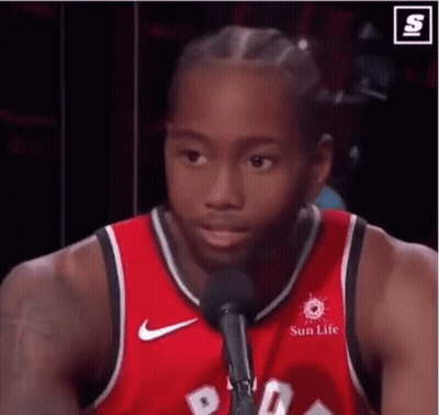 A Basketball Player Is Talking Into A Microphone While Wearing A Red Jersey That Says Sun Life . GIF