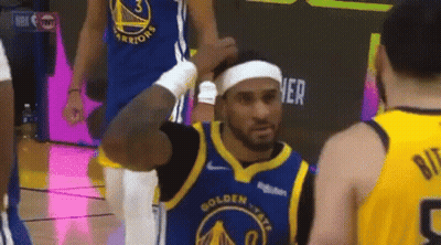 A Basketball Player Is Wearing A Headband And Talking To Another Player On The Court . GIF