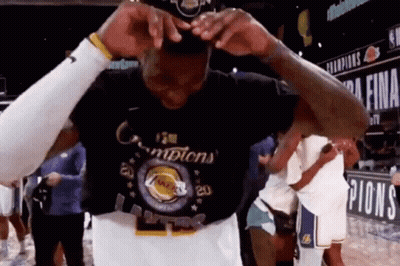 A Basketball Player Is Wearing A T-Shirt That Says Champions . GIF