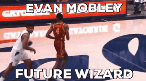 A Basketball Player Named Evan Mobley Dribbles The Ball During A Game GIF