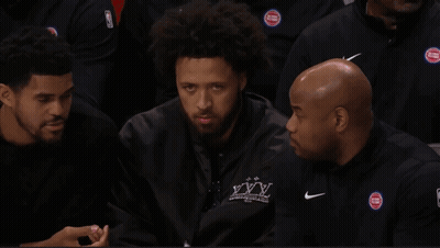 A Basketball Player Named J Cole Is Sitting In The Stands With His Teammates GIF