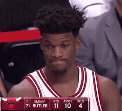 A Basketball Player Named Jimmy Butler Is Sitting On The Bench GIF
