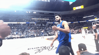A Basketball Player Stands In Front Of A Ball Arena Sign GIF