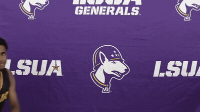 A Basketball Player Stands In Front Of A Purple Lsu Generals Banner GIF