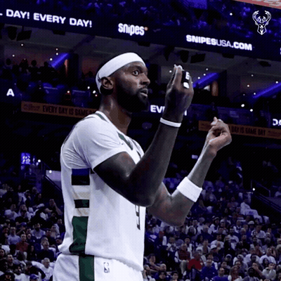 A Basketball Player Stands In Front Of A Snipes Sign GIF