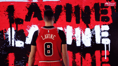 A Basketball Player Stands In Front Of A Wall That Says Lavine 8 GIF