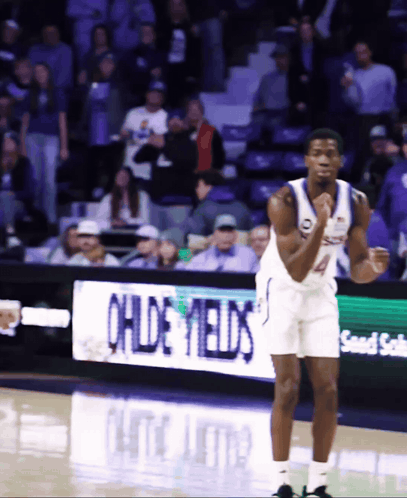 A Basketball Player Stands In Front Of An Ohde Yields Banner GIF