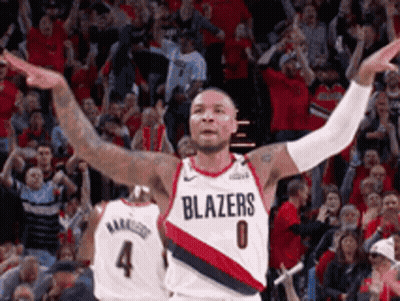 A Basketball Player Wearing A Blazers Jersey Is Celebrating GIF