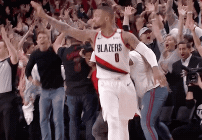 A Basketball Player Wearing A Blazers Jersey Is Surrounded By Fans GIF