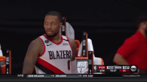 A Basketball Player Wearing A Blazers Jersey Stands On The Court GIF