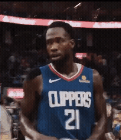 A Basketball Player Wearing A Blue Jersey With The Number 21 On It . GIF