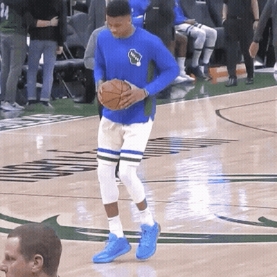 A Basketball Player Wearing A Blue Shirt That Says Bucks On It GIF