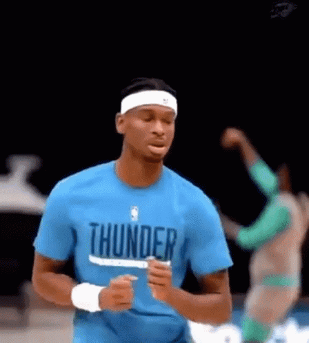 A Basketball Player Wearing A Blue Shirt That Says Thunder Is Running On The Court . GIF
