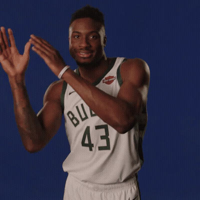 A Basketball Player Wearing A Buck 43 Jersey Is Clapping His Hands GIF