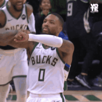 A Basketball Player Wearing A Bucks Jersey Giving A Fist Bump GIF