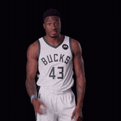 A Basketball Player Wearing A Bucks Jersey Holds His Hands To His Head GIF
