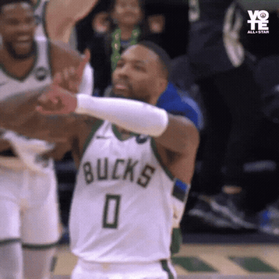 A Basketball Player Wearing A Bucks Jersey Is Giving A Thumbs Up GIF