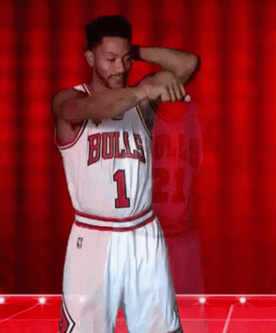 A Basketball Player Wearing A Bulls Jersey And Shorts Is Dancing On A Stage . GIF