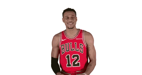 A Basketball Player Wearing A Bulls Jersey Is Clapping His Hands GIF