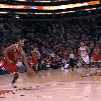 A Basketball Player Wearing A Bulls Jersey Is Dribbling The Ball GIF
