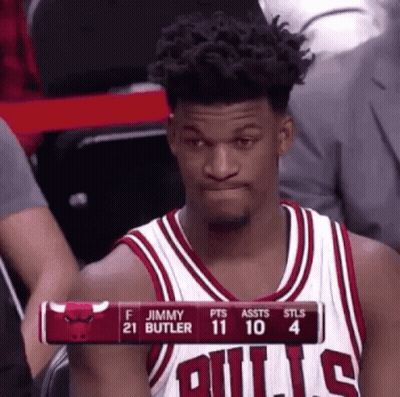 A Basketball Player Wearing A Bulls Jersey Is Sitting In The Stands Watching A Game . GIF