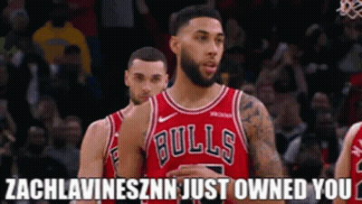 A Basketball Player Wearing A Bulls Jersey Stands Next To Another Player . GIF