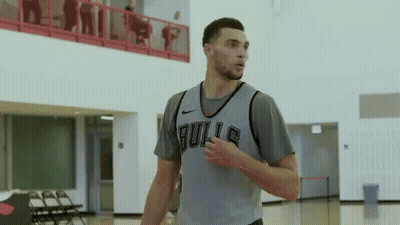 A Basketball Player Wearing A Bulls Jersey Stands On A Court GIF