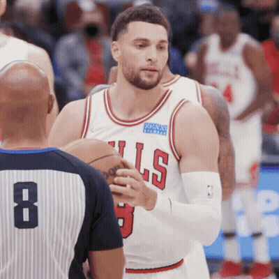 A Basketball Player Wearing A Bulls Jersey Talks To A Referee GIF