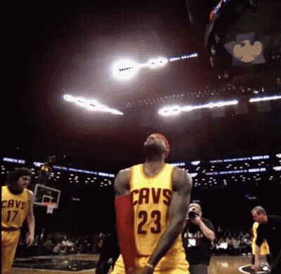 A Basketball Player Wearing A Cavs Jersey Is Jumping In The Air GIF