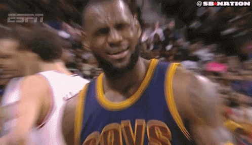 A Basketball Player Wearing A Cavs Jersey Is Smiling In Front Of A Crowd GIF