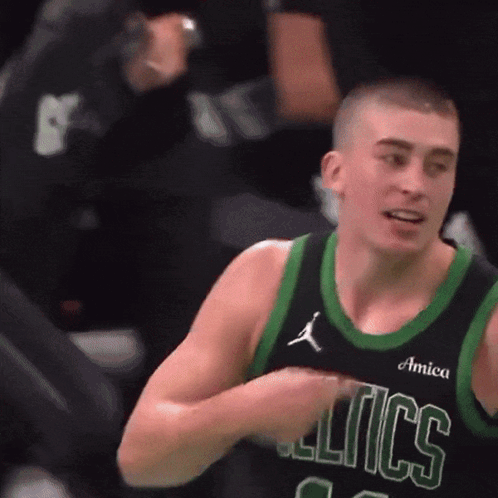 A Basketball Player Wearing A Celtics Jersey Holds His Hands To His Chest GIF