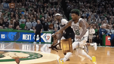 A Basketball Player Wearing A Celtics Jersey Is Running With A Trophy In His Hand GIF